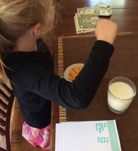 Here she is counting her money after ordering her milk and crackers, to be sure she would have enough.